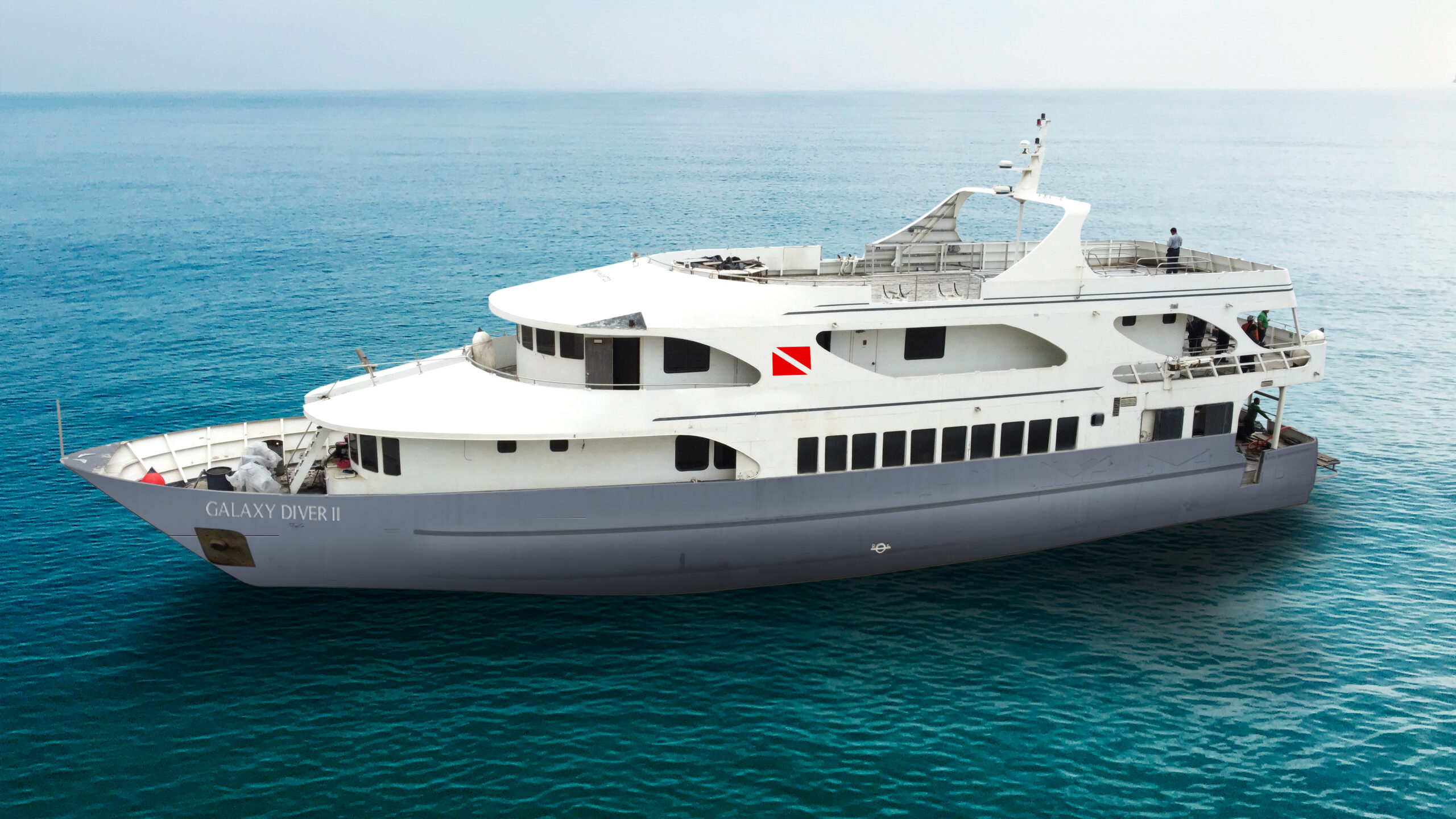 A large white and gray dive yacht named 