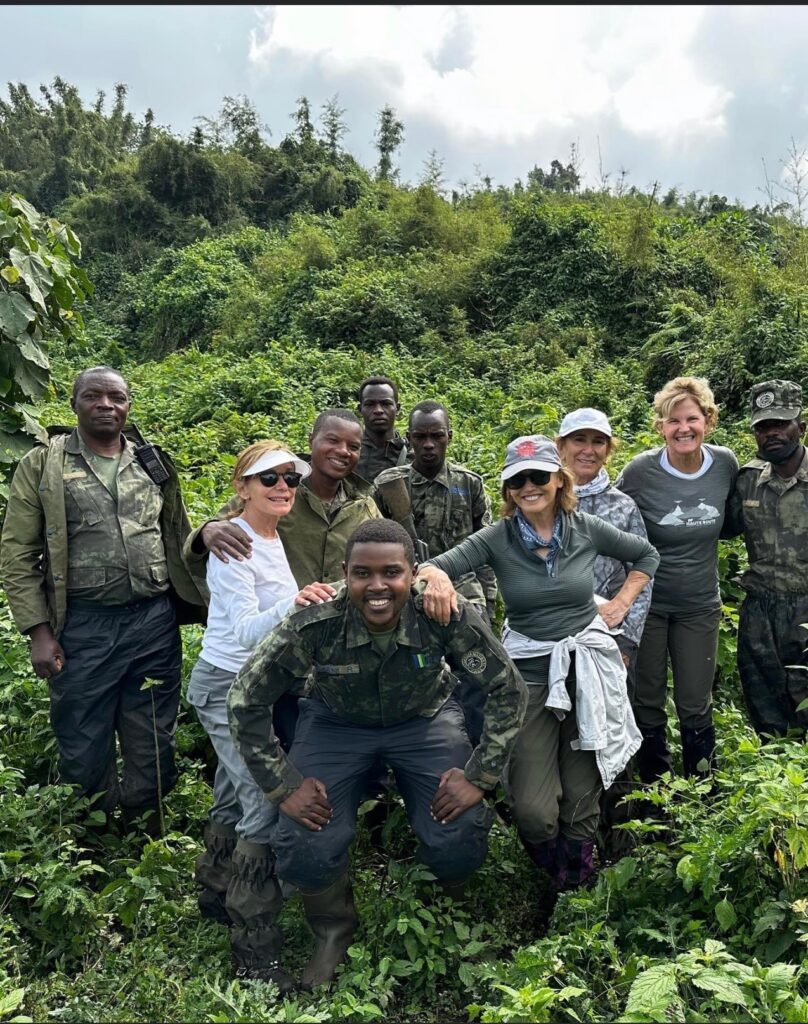group of female travelers gorilla trekking with expert safari guides in Volcanoes National Park in Rwanda, Africa
