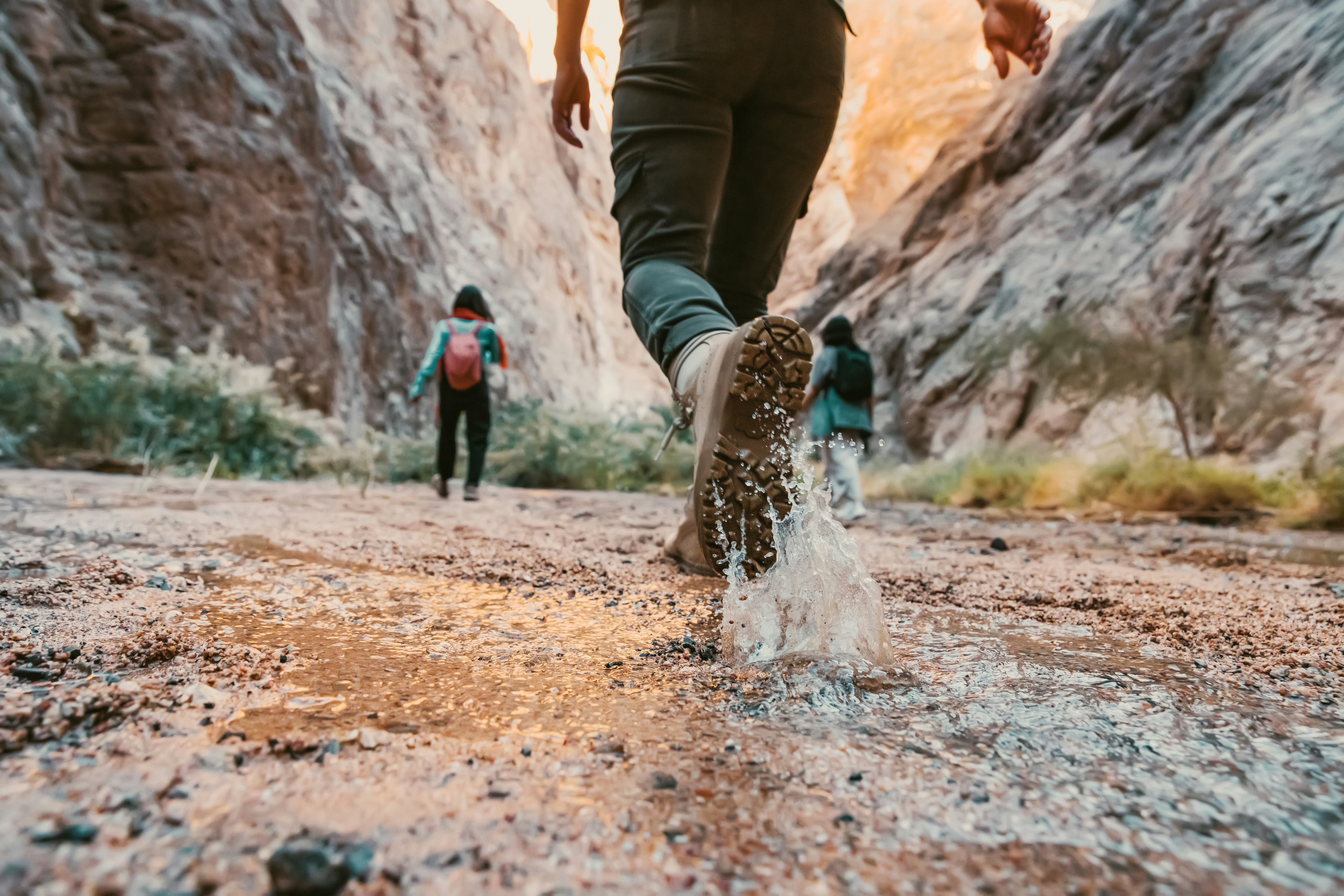 female hiker running with bare feet on water in nature in a national park