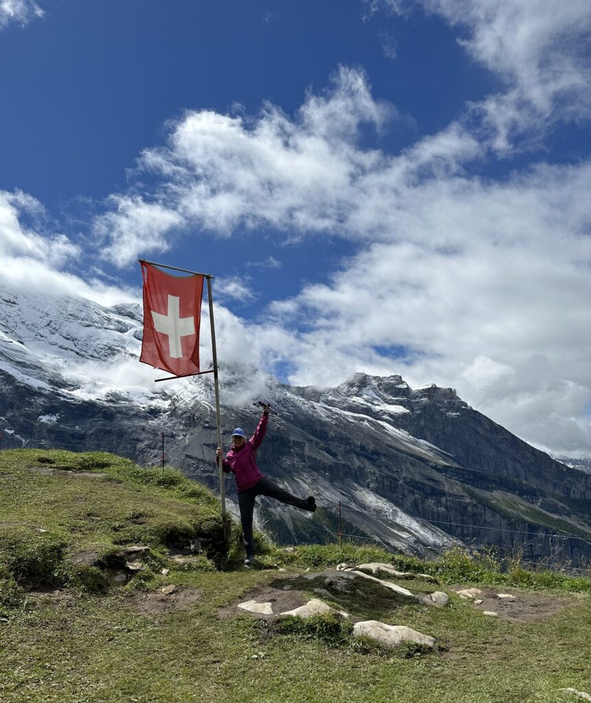 female traveler hiking on a village to village hiking tour in Alps region near Mont Blanc, Matterhorn, and Eiger