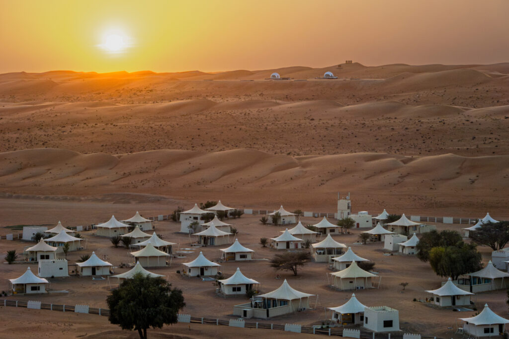 travelers encountering Bedouin tribes in the rolling dunes of the Wahiba Sands in Oman, Middle East