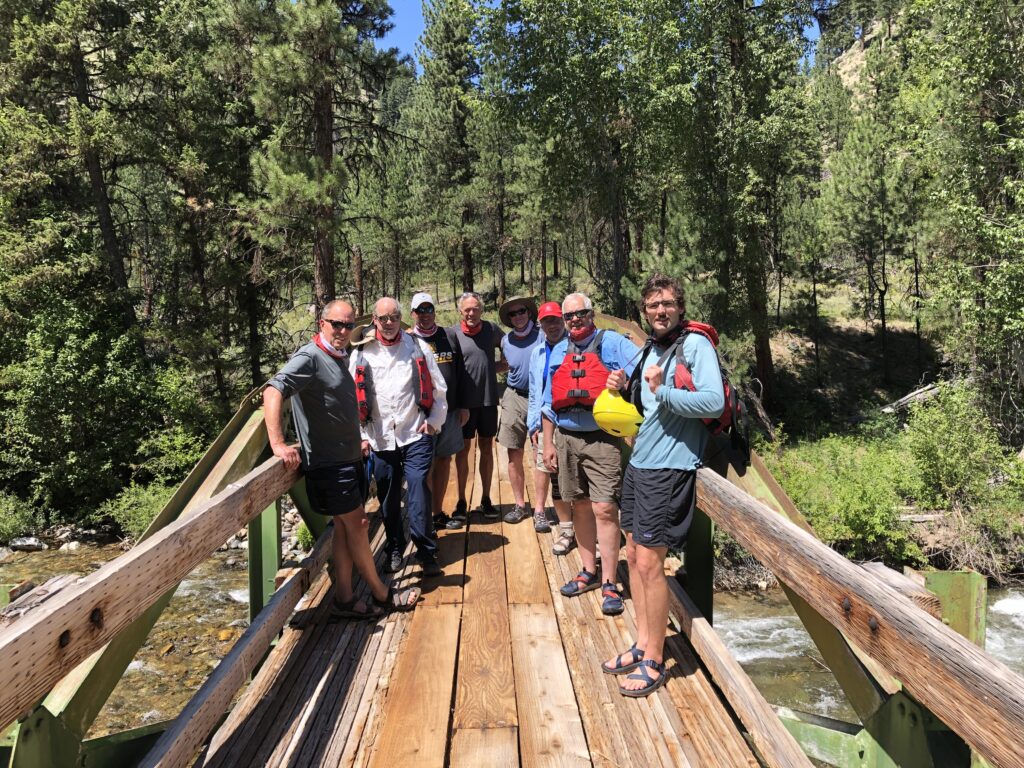 group of men standing around in the sun on bridge near Idaho's Middle Fork of the Salmon River in North America