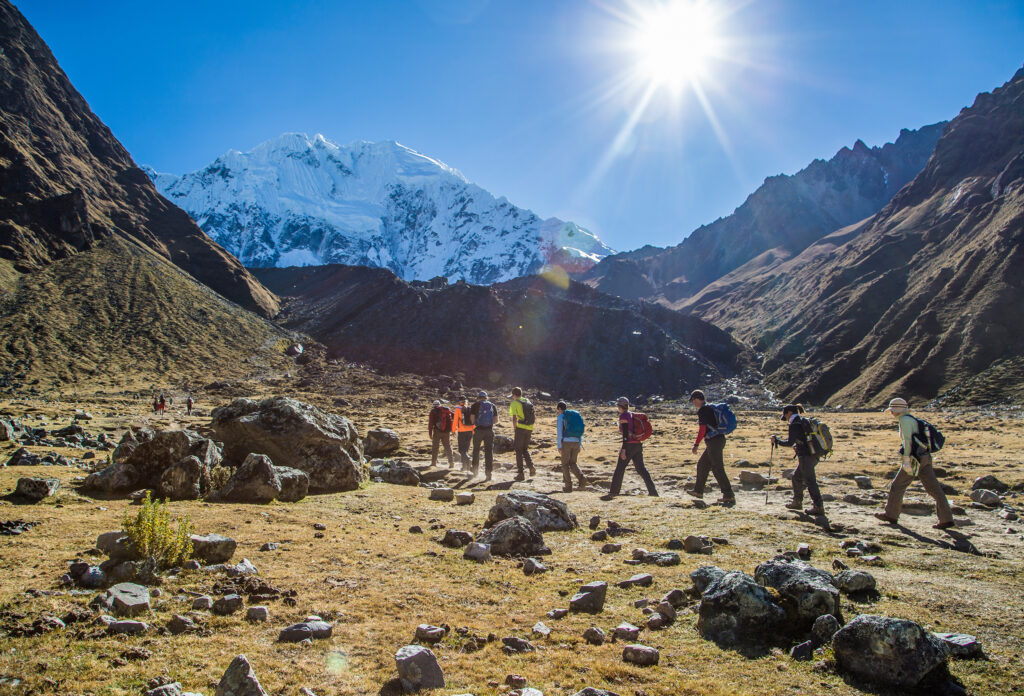 group of hikers hiking in the rugged wilderness of the Andes on a lodge-to-lodge trek to Machu Picchu on the Salkantay in the summer