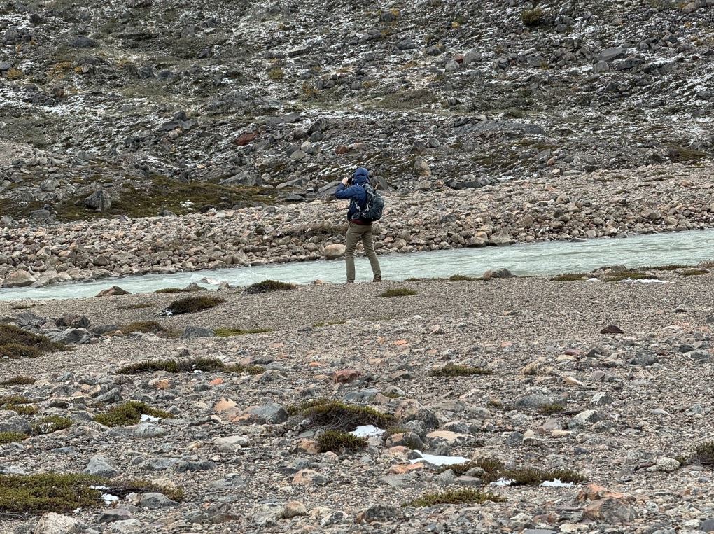 male traveler from Diane's group looking out with binoculars at Fritz Roy in Argentina during a hiking trip