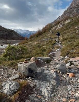 solo traveler on rugged terrain during hiking trip to Argentina