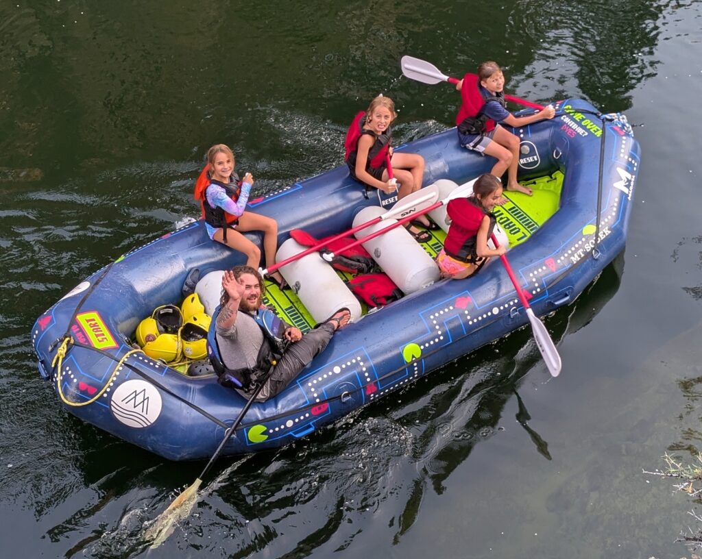 kids enjoying paddle boats in the rapids in Idaho Middle Fork
