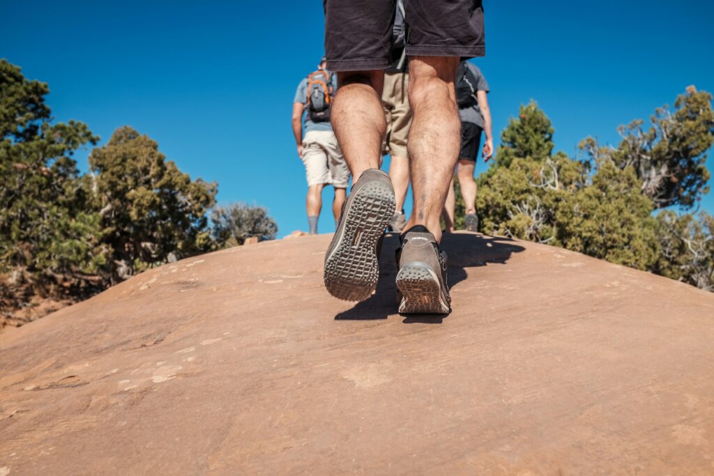 hiking with weighted bags with group of friends on trail
