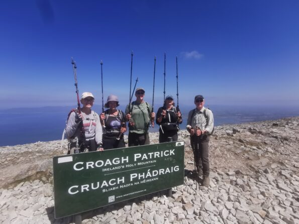 ascending a pilgrim trail to Croagh Patrick with hikers in Ireland, Europe