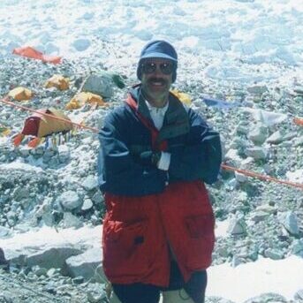 postcard of John Shively with Khumbu Icefall in background in the Himalayas