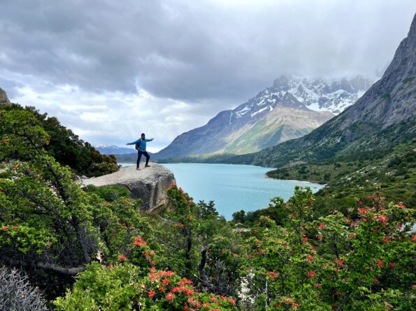 hiker on top of mountain near lake landscapes in Torres del Paine in Patagonia