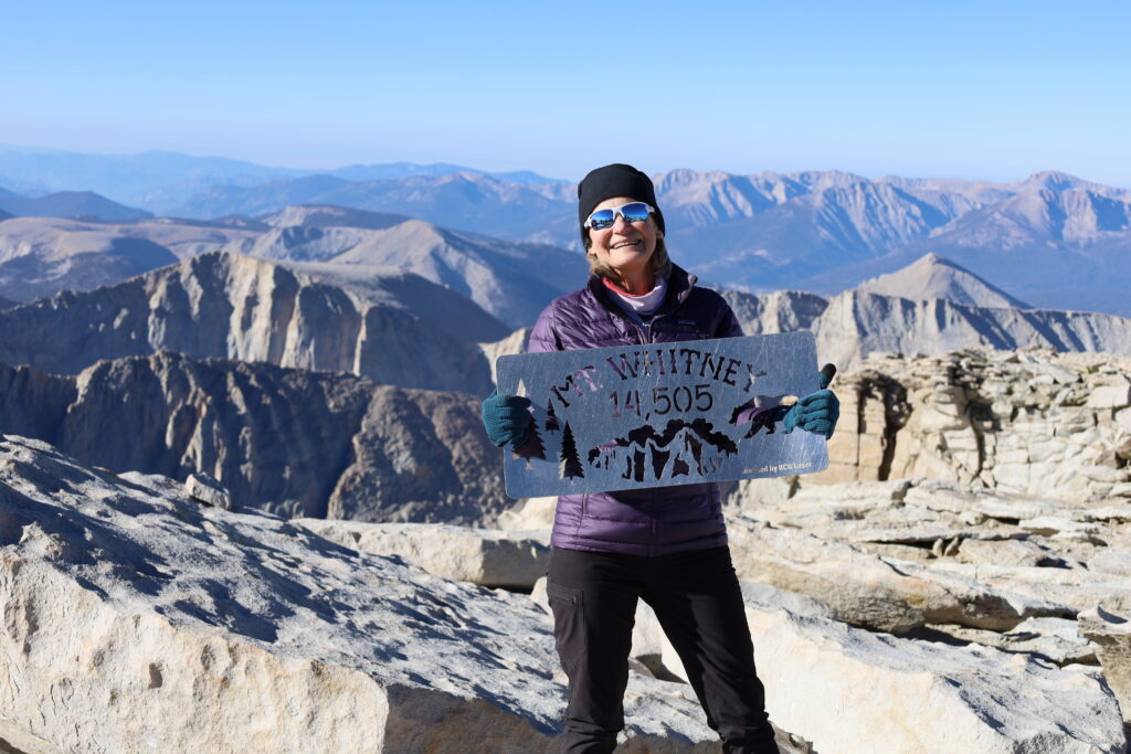 female climber making successful climb up Mt Whitney on hike in John Muir Woods