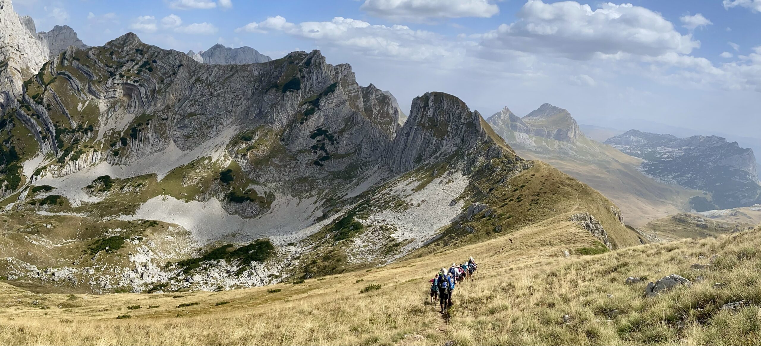nature photography - sweeping mountainous landscapes with a hiking trek in progress in Via Dinarica