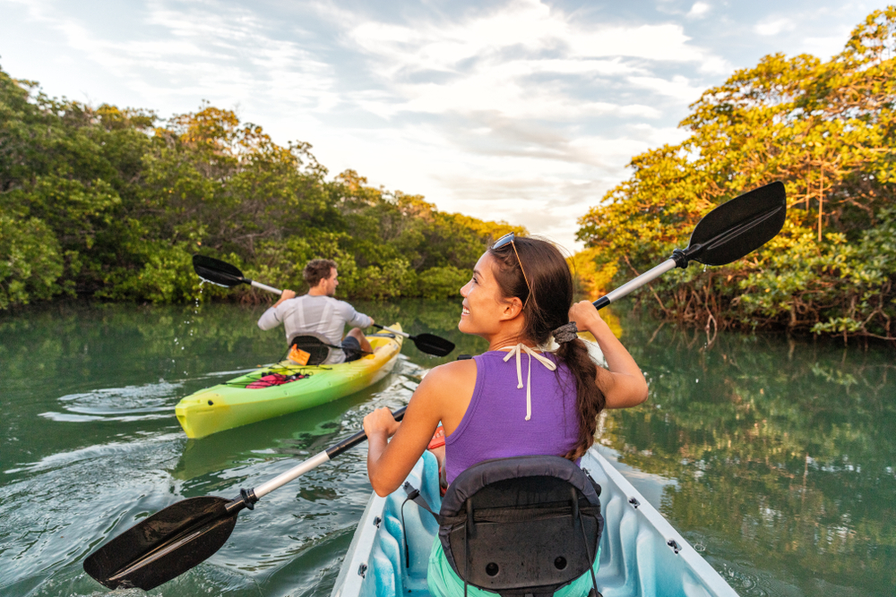 woman kayaking with her best friends in Biscayne National Park in the sun in Florida