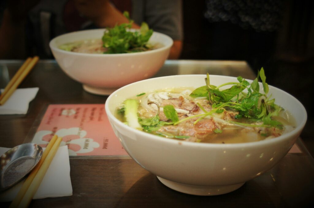 eating a warm bowl of homemade pho in Vietnam, Asia