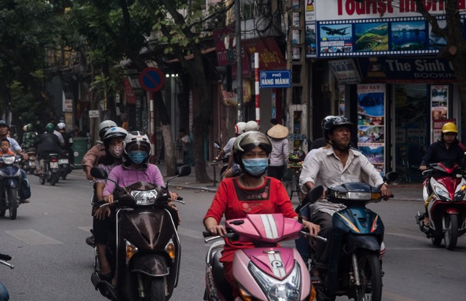 City Hanoi is bustling with traffic and motorbikes on street in Vietnam, Asia