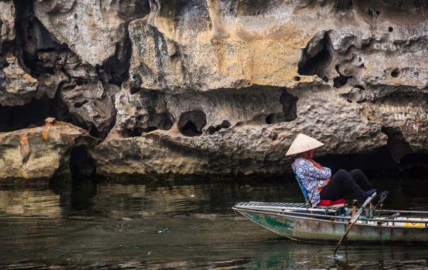 visitors can enjoy being on a rowboat on a meandering river in ninh binh, vietnam, in asia