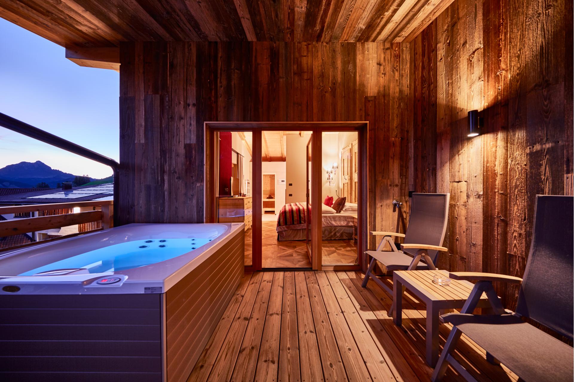 Hotel Fanes - terrace with jacuzzi room on Dolomites premier lodging adventure
