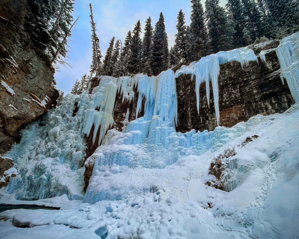 hiking trail to frozen waterfall in Johnston Canyon in wintertime in Canada Banff National Park