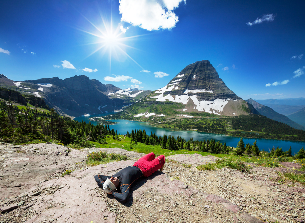 Hiker laying down in Glacier National Park, Montana